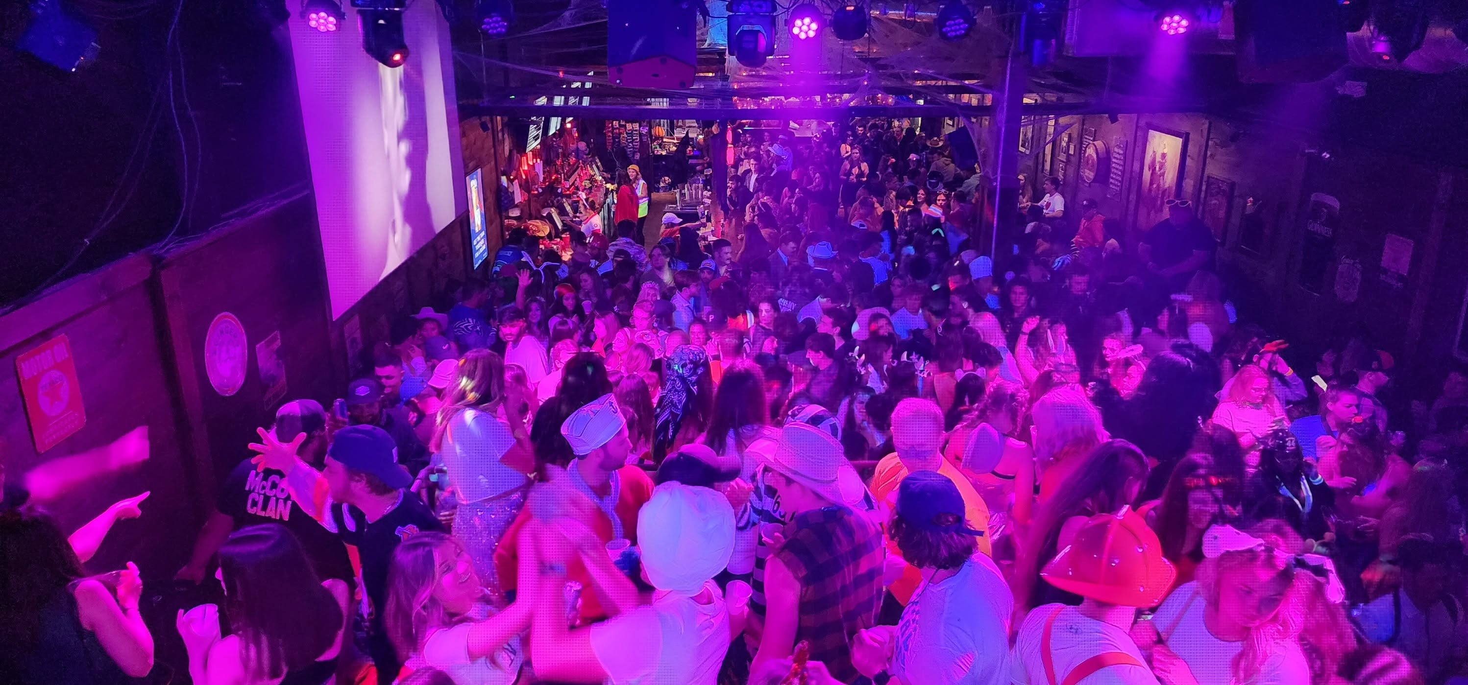 Packed dance floor at McCoy’s under pink, purple and blue lighting